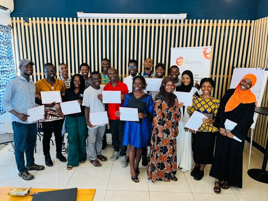 Graduates holding certificates at the end of a CIJ training program