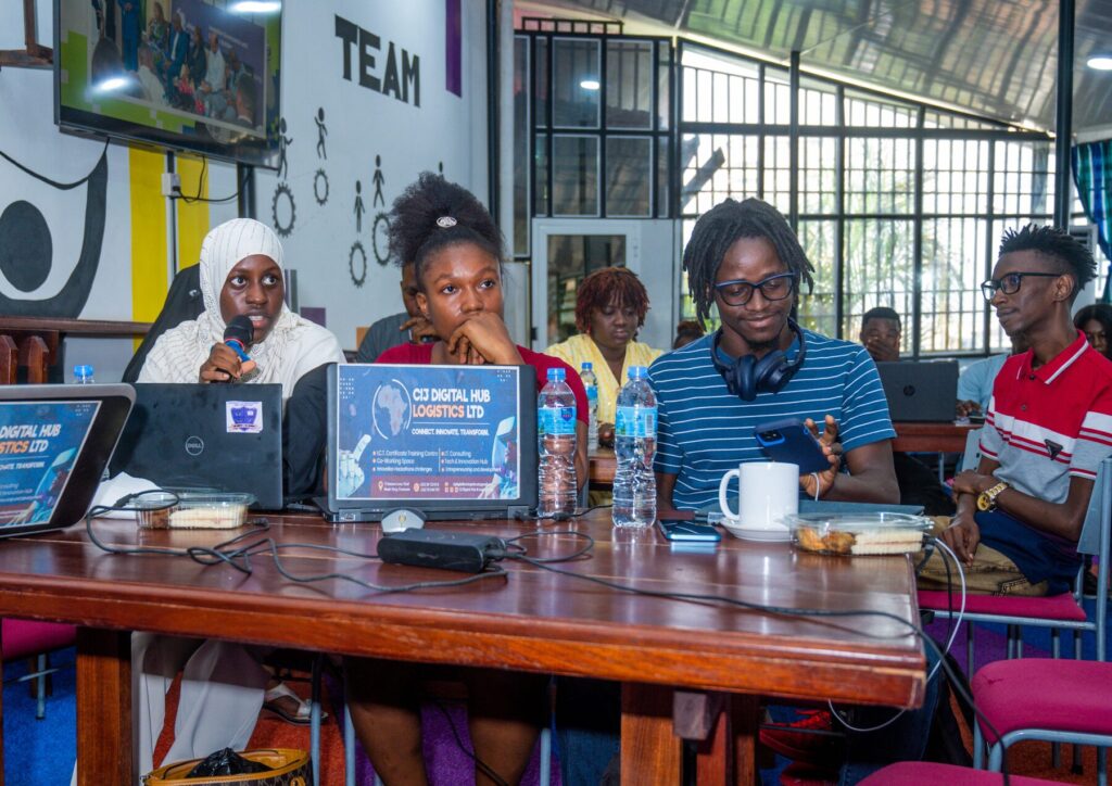 Women entrepreneurs working on laptops around a table during a workshop